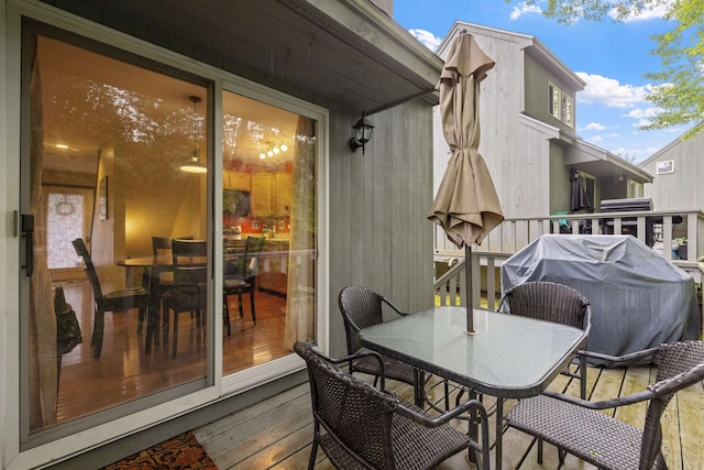 6 Cumberland Rd Unit 12, Gilford, NH 03249 - wooden terrace with outdoor dining space and a grill