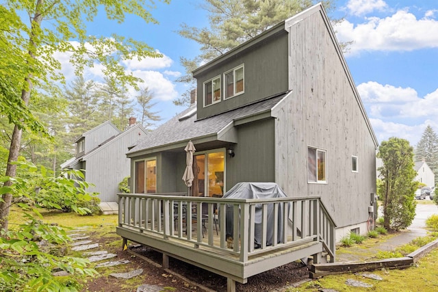 6 Cumberland Rd Unit 12, Gilford, NH 03249 - rear view of property featuring a shingled roof and a wooden deck