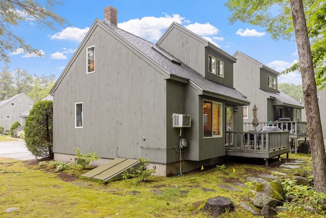 6 Cumberland Rd Unit 12, Gilford, NH 03249 - back of house featuring a wooden deck, a chimney, roof with shingles, and a wall unit AC