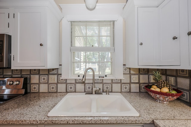 42 Lyndon St, Concord, NH 03301 - kitchen featuring stainless steel microwave, white cabinets, and decorative backsplash