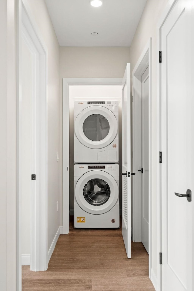 18 Artisan Dr Unit 416, Salem, NH 03079 - washroom with stacked washer and clothes dryer, light wood-style flooring, and recessed lighting