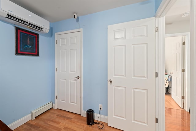 70 Riverside Dr, Allenstown, NH 03275 - unfurnished bedroom featuring an AC wall unit, light wood finished floors, and a baseboard heating unit