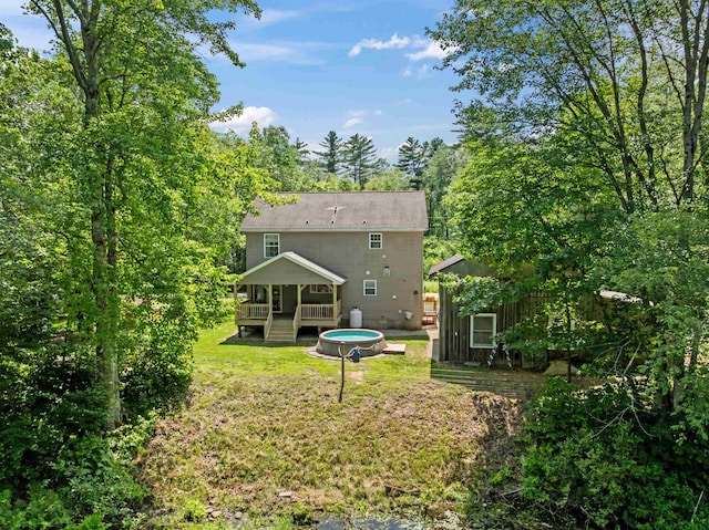 70 Riverside Dr, Allenstown, NH 03275 - back of property featuring a yard, a deck, and an outbuilding