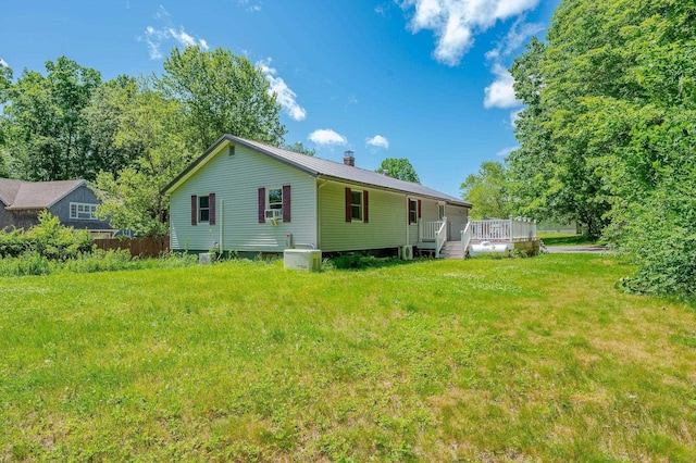 15B Vine St, South Berwick, ME 03908 - back of property featuring a chimney, a lawn, a deck, a metal roof, and cooling unit
