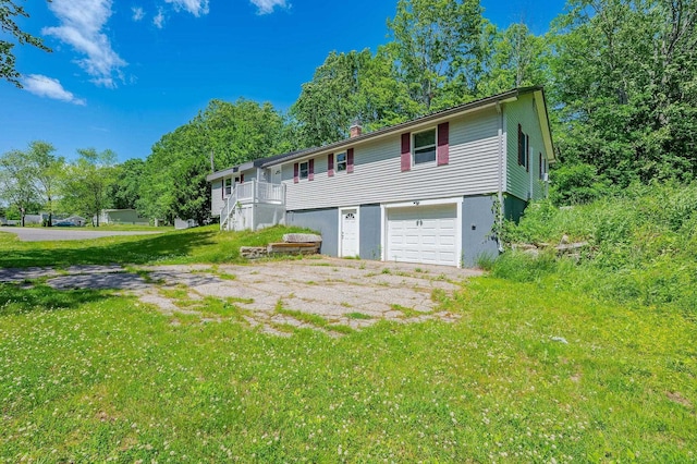 15B Vine St, South Berwick, ME 03908 - back of house with a garage, a chimney, and a lawn