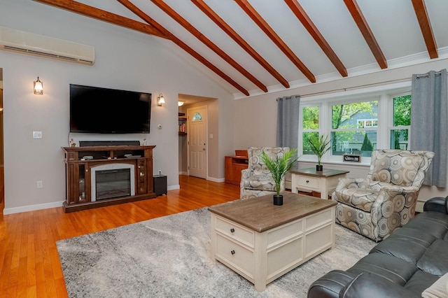 15B Vine St, South Berwick, ME 03908 - living room with a wall mounted air conditioner, beamed ceiling, light wood finished floors, and high vaulted ceiling