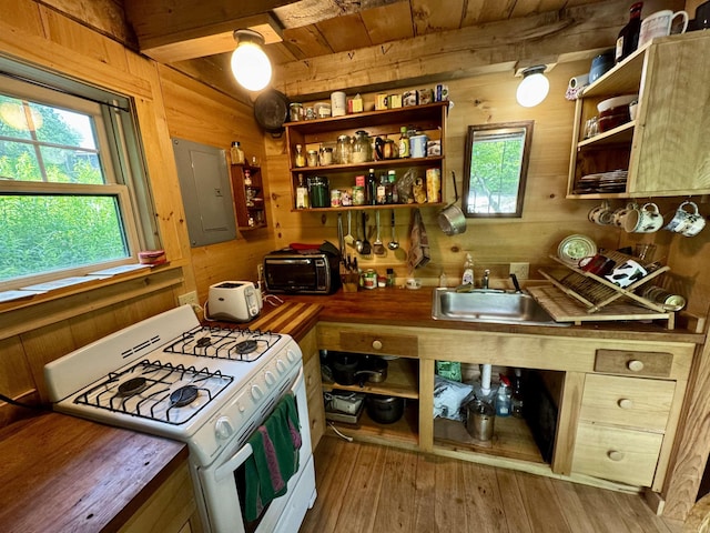 14 Threshold Way, Corinth, VT 05040 - kitchen featuring white gas stove, electric panel, open shelves, wooden walls, and plenty of natural light