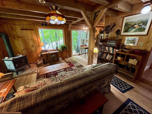 14 Threshold Way, Corinth, VT 05040 - living area featuring wood finished floors, beamed ceiling, wooden walls, and a wood stove
