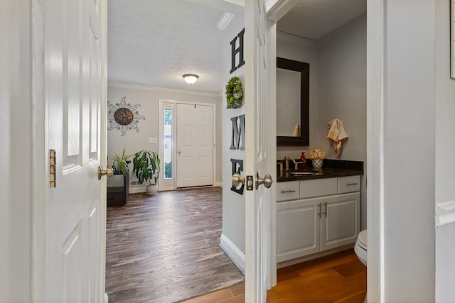 13 Rangers Dr Unit B, Hudson, NH 03051 - foyer entrance with wood finished floors, crown molding, and a textured ceiling