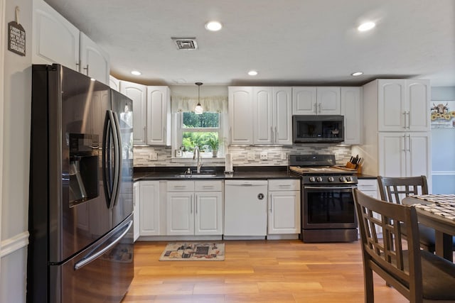 13 Rangers Dr Unit B, Hudson, NH 03051 - kitchen featuring stainless steel appliances, dark countertops, white cabinetry, backsplash, and recessed lighting