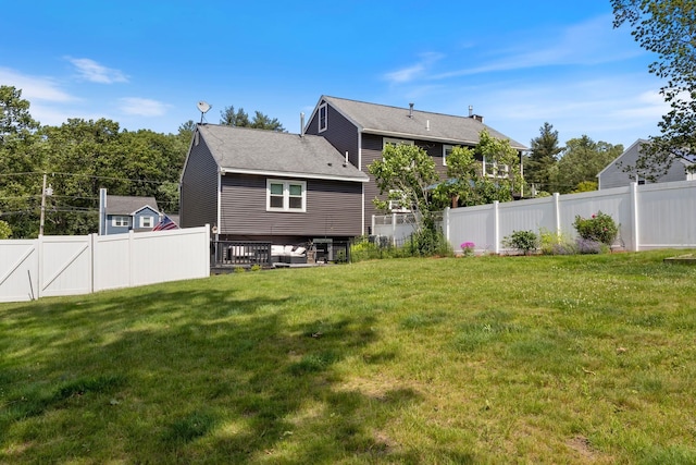 13 Rangers Dr Unit B, Hudson, NH 03051 - back of property with a fenced backyard and roof with shingles