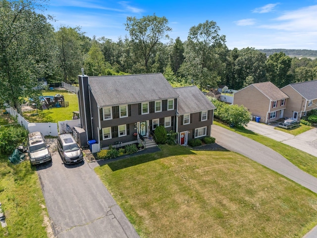 13 Rangers Dr Unit B, Hudson, NH 03051 - view of front of home featuring asphalt driveway, a front yard, and a chimney
