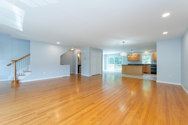 70B Shadowbrook Dr Unit 70B, Hudson, NH 03051 - unfurnished living room with stairs, light wood-type flooring, a chandelier, and recessed lighting