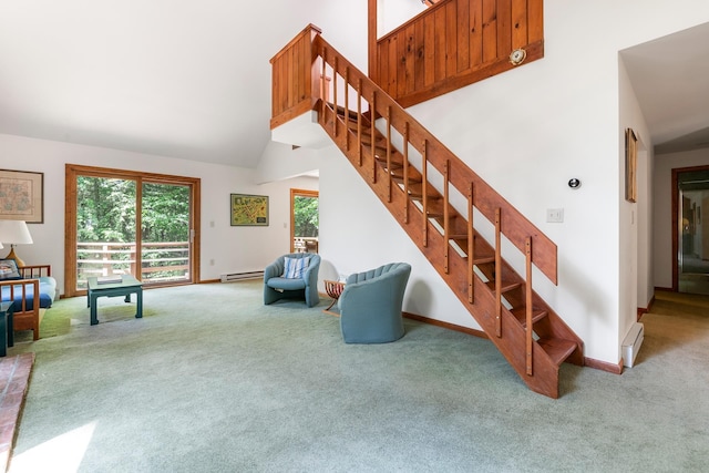 49 Longwood Dr, Grantham, NH 03753 - carpeted living area featuring stairs, high vaulted ceiling, and a baseboard radiator