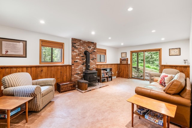 49 Longwood Dr, Grantham, NH 03753 - living room with wainscoting, wooden walls, plenty of natural light, recessed lighting, and a wood stove