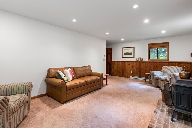 49 Longwood Dr, Grantham, NH 03753 - carpeted living room with a baseboard heating unit, a wainscoted wall, recessed lighting, wood walls, and a wood stove