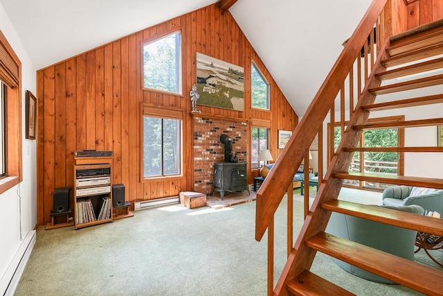 49 Longwood Dr, Grantham, NH 03753 - stairs with a baseboard radiator, a wood stove, carpet, wood walls, and high vaulted ceiling