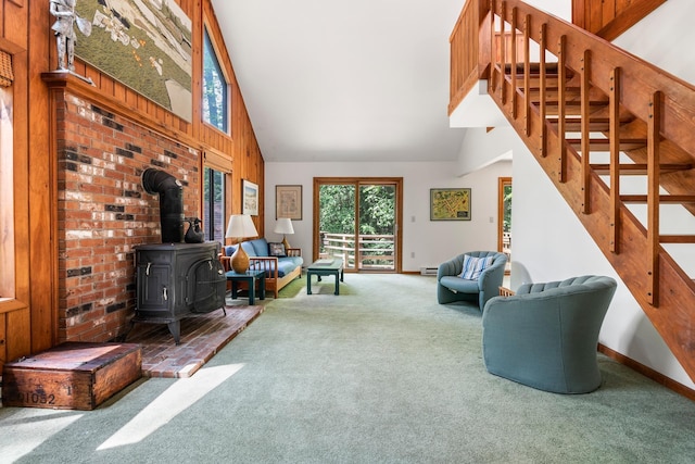 49 Longwood Dr, Grantham, NH 03753 - carpeted living area featuring high vaulted ceiling, a wood stove, stairway, and wooden walls