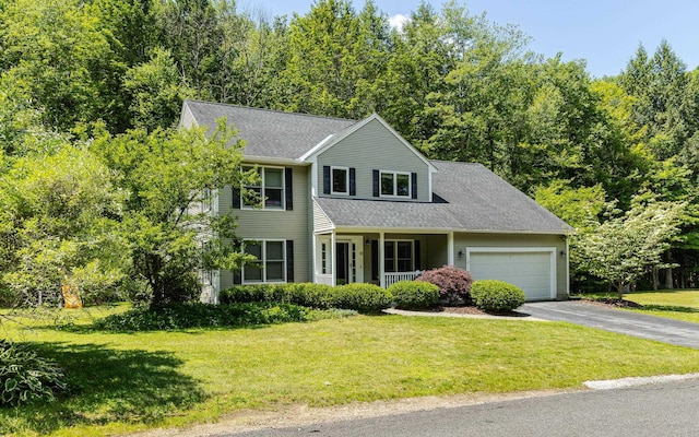 81 Summit Ridge Dr, Keene, NH 03431 - view of front of house featuring a porch, asphalt driveway, a garage, a front lawn, and roof with shingles