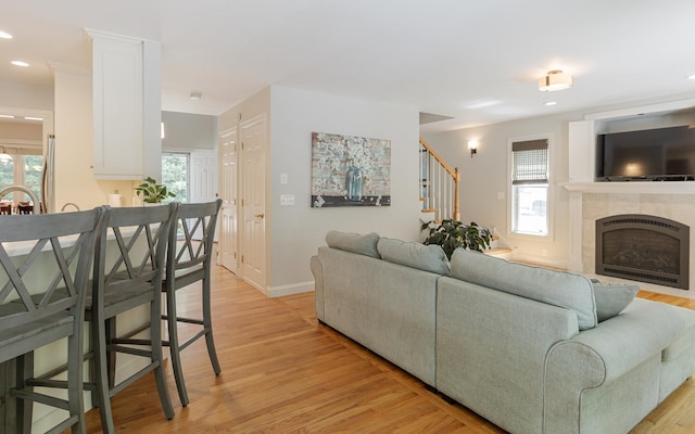 81 Summit Ridge Dr, Keene, NH 03431 - living area featuring light wood-style floors, plenty of natural light, stairs, a tile fireplace, and recessed lighting