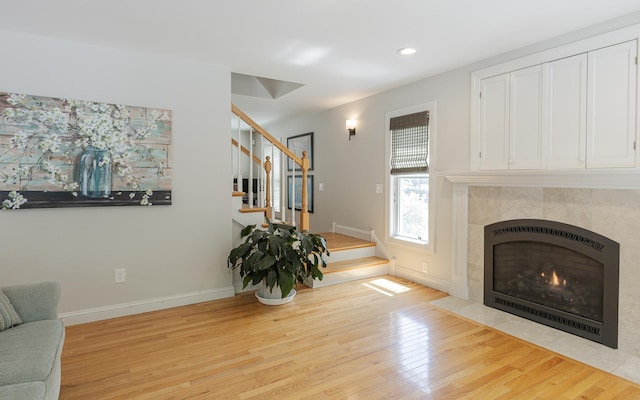 81 Summit Ridge Dr, Keene, NH 03431 - living room with stairway, light wood-style flooring, recessed lighting, and a tile fireplace