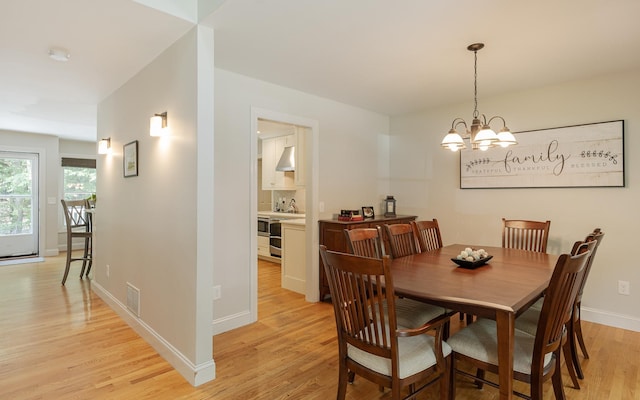 81 Summit Ridge Dr, Keene, NH 03431 - dining space featuring light wood-style floors and a chandelier