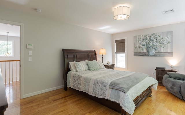 81 Summit Ridge Dr, Keene, NH 03431 - bedroom with light wood-type flooring and a chandelier