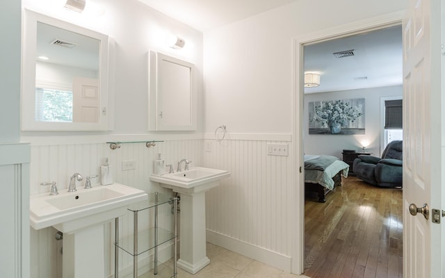 81 Summit Ridge Dr, Keene, NH 03431 - bathroom with wainscoting, hardwood / wood-style flooring, and ensuite bathroom