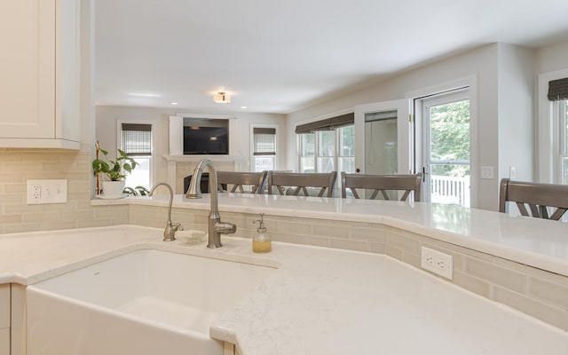 81 Summit Ridge Dr, Keene, NH 03431 - kitchen featuring decorative backsplash, light stone countertops, and white cabinetry