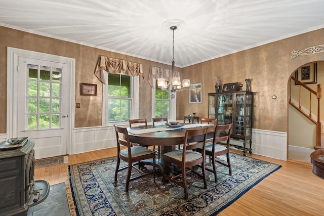 223 Atlantic Ave, North Hampton, NH 03862 - dining room featuring stairs, wood finished floors, a chandelier, ornamental molding, and wainscoting