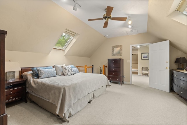 223 Atlantic Ave, North Hampton, NH 03862 - bedroom with rail lighting, vaulted ceiling, light carpet, and a ceiling fan