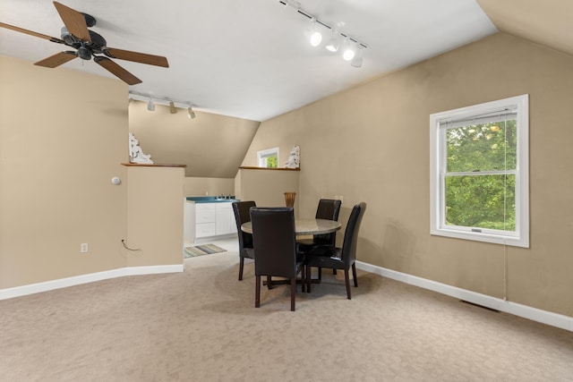 223 Atlantic Ave, North Hampton, NH 03862 - dining area featuring rail lighting, vaulted ceiling, light carpet, and ceiling fan