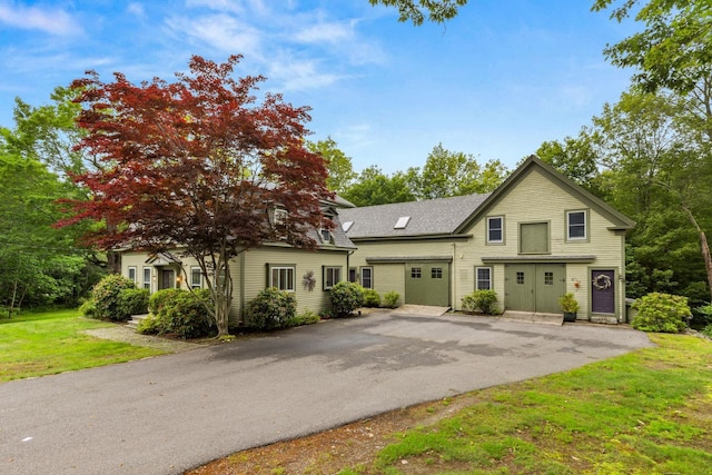 223 Atlantic Ave, North Hampton, NH 03862 - view of front of house with driveway, a front lawn, and an attached garage