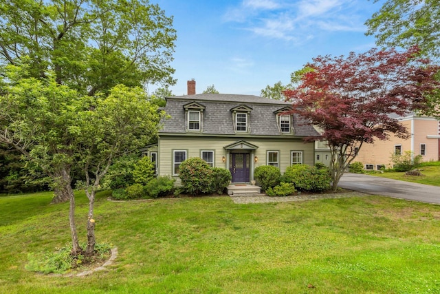 223 Atlantic Ave, North Hampton, NH 03862 - view of front of home featuring a chimney, a front lawn, driveway, and a shingled roof