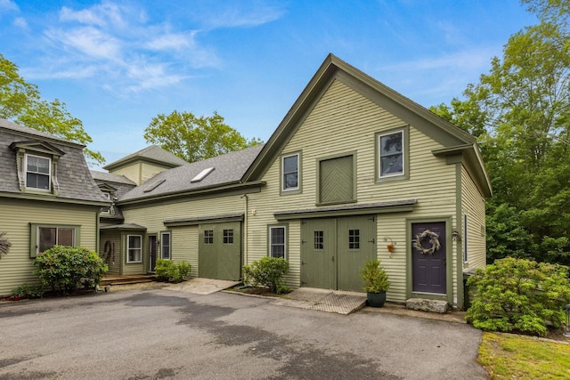 223 Atlantic Ave, North Hampton, NH 03862 - view of front facade featuring a shingled roof and a wooden deck