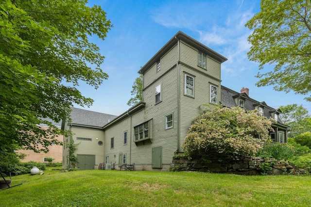 223 Atlantic Ave, North Hampton, NH 03862 - back of property featuring a lawn and a chimney