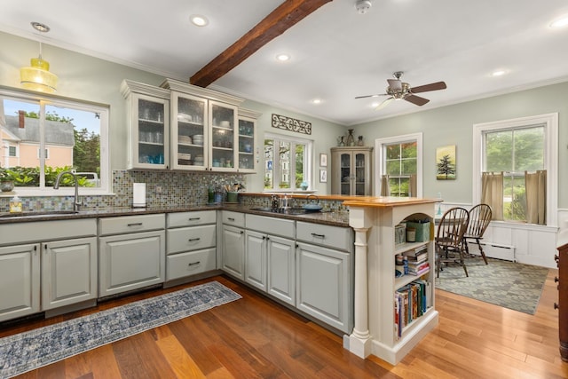 223 Atlantic Ave, North Hampton, NH 03862 - kitchen featuring a peninsula, wood finished floors, plenty of natural light, ornamental molding, and recessed lighting