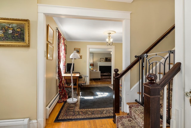 96 Madbury Rd, Durham, NH 03824 - entrance foyer featuring a baseboard heating unit, wood finished floors, ornamental molding, and stairs