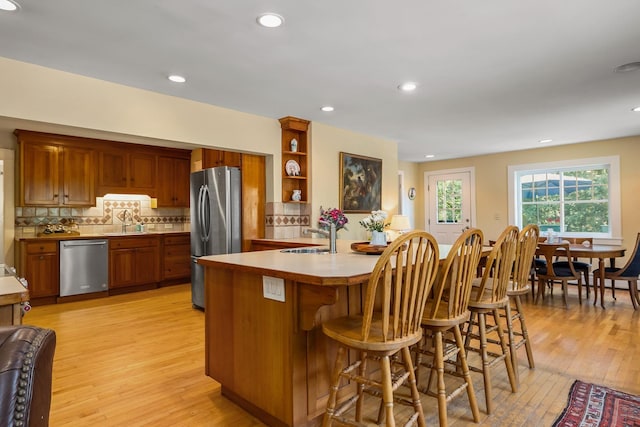 96 Madbury Rd, Durham, NH 03824 - kitchen with stainless steel appliances, light wood-type flooring, brown cabinetry, and recessed lighting