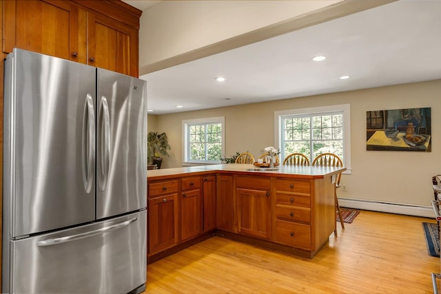 96 Madbury Rd, Durham, NH 03824 - kitchen featuring freestanding refrigerator, a baseboard heating unit, brown cabinets, a peninsula, and recessed lighting