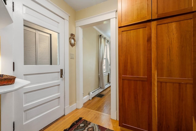 96 Madbury Rd, Durham, NH 03824 - corridor featuring light wood-style floors and a baseboard radiator