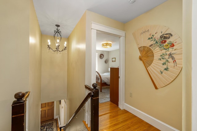 96 Madbury Rd, Durham, NH 03824 - corridor featuring an upstairs landing, light wood-type flooring, and a chandelier