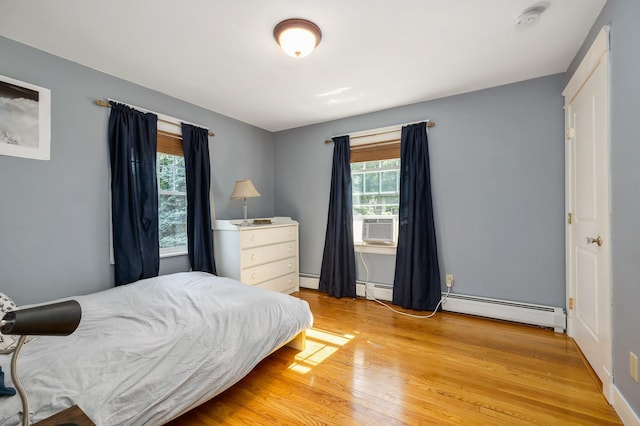 96 Madbury Rd, Durham, NH 03824 - bedroom featuring a baseboard radiator, multiple windows, and light wood-style floors