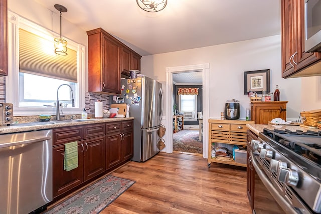 1076 Merrill St, Manchester, NH 03103 - kitchen with stainless steel appliances, light wood-style floors, pendant lighting, and light countertops