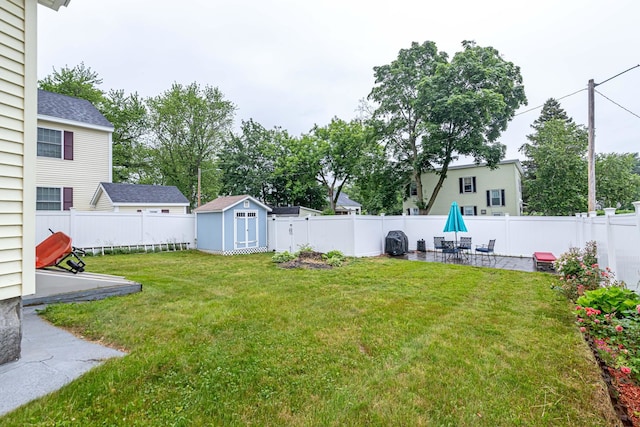 1076 Merrill St, Manchester, NH 03103 - fenced backyard with a patio and a storage shed