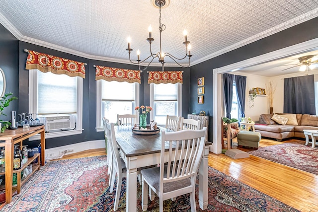 1076 Merrill St, Manchester, NH 03103 - dining room featuring wood finished floors, a chandelier, cooling unit, ornamental molding, and ceiling fan
