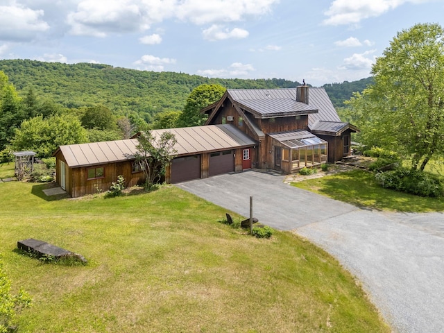 2208-2432 Backway Rd, Corinth, VT 05039 - view of front of home featuring a standing seam roof, a garage, a chimney, asphalt driveway, and a metal roof