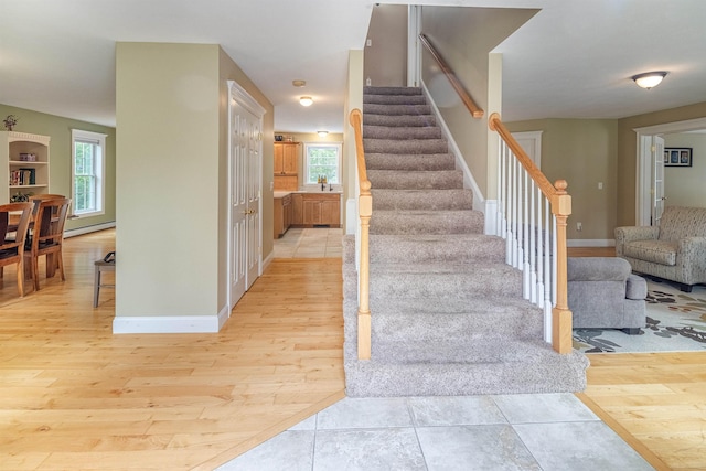 203 Blackwater Rd, Somersworth, NH 03878 - stairs featuring wood finished floors, plenty of natural light, and a baseboard heating unit