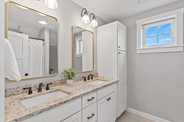 16 Daniels Dr, Lee, NH 03861 - bathroom with double vanity and a shower with curtain