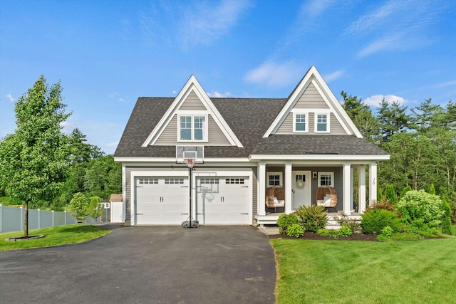 16 Daniels Dr, Lee, NH 03861 - shingle-style home with driveway, a shingled roof, a garage, and covered porch